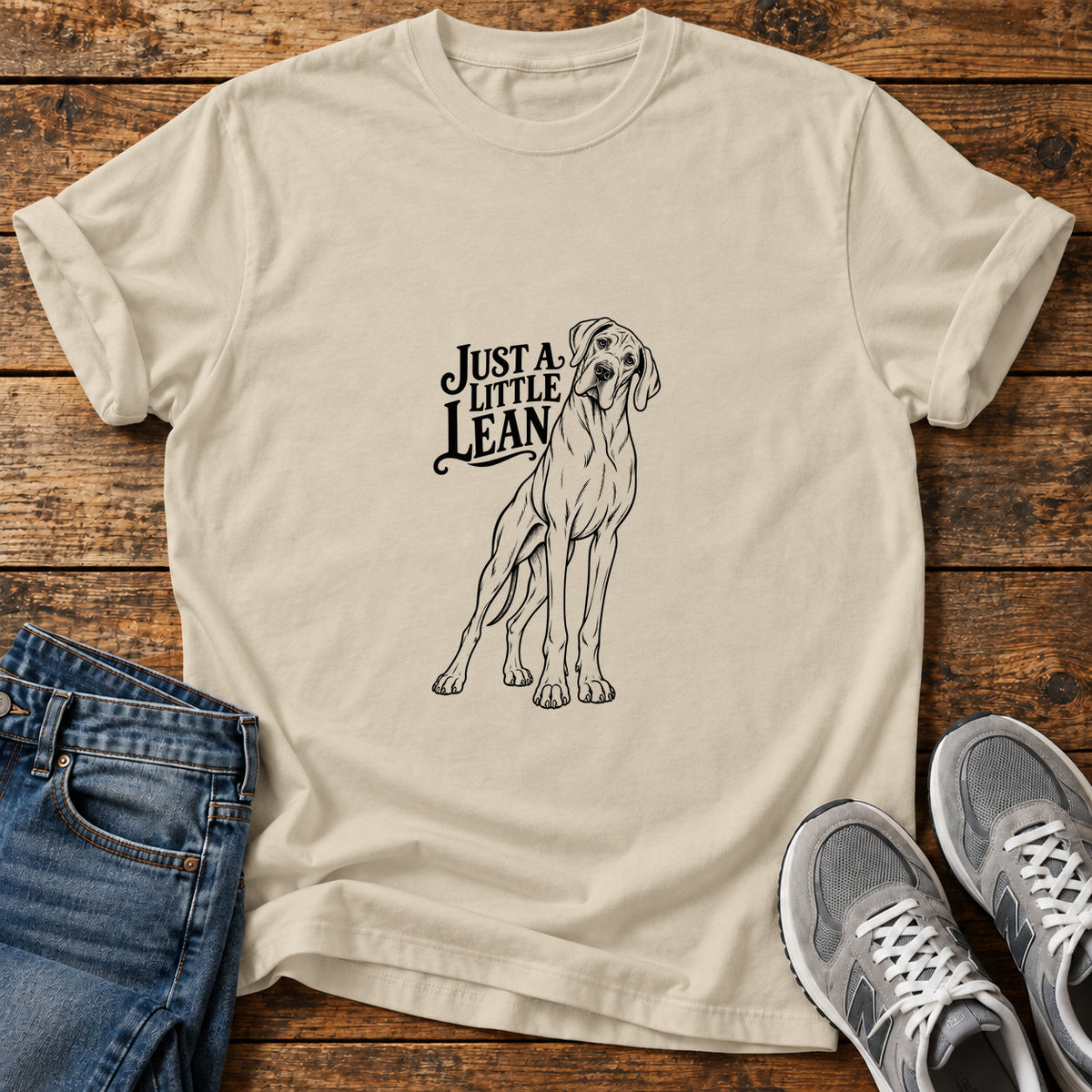 Just A Lean Great Dane graphic T-shirt in Sand, shown on a flat-lay shirt mockup