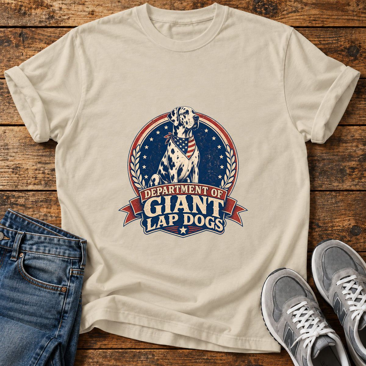 Giant Lap Dogs Great Dane graphic T-shirt in Sand, shown on a flat-lay shirt mockup