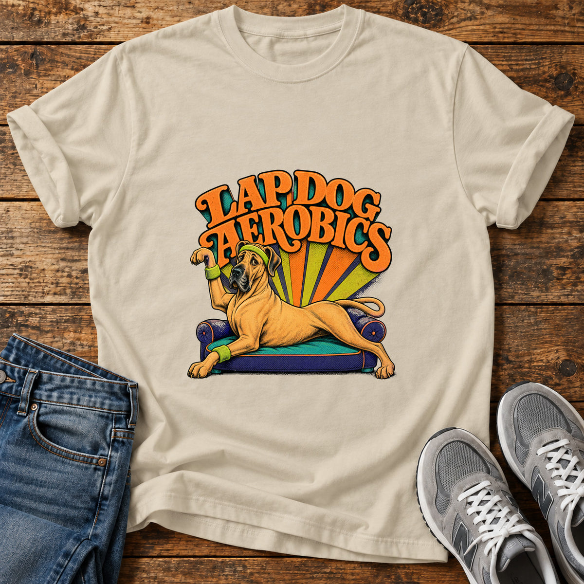Lap Dog Aerobics Great Dane graphic T-shirt in Sand, shown on a flat-lay shirt mockup