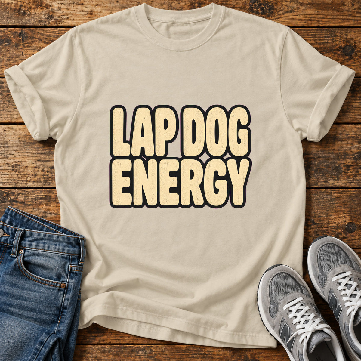Lap Dog Energy Great Dane graphic T-shirt in Sand, shown on a flat-lay shirt mockup