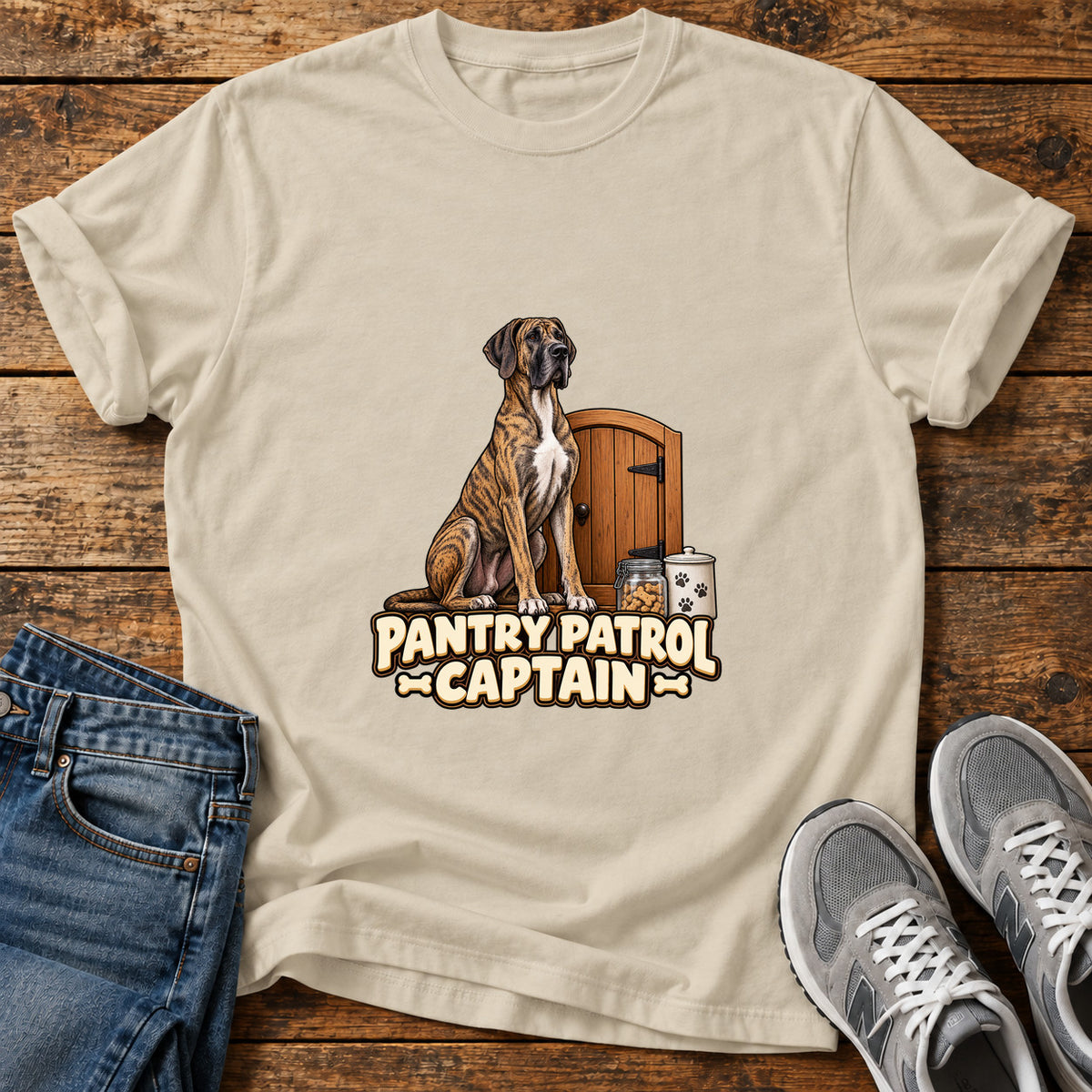 Pantry Patrol Captain Great Dane graphic T-shirt in Sand, shown on a flat-lay shirt mockup