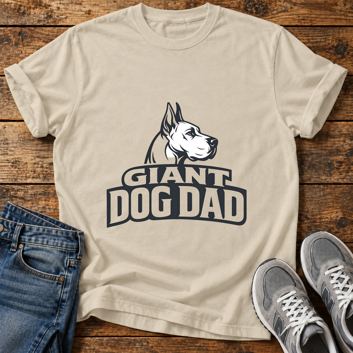 Giant Dog Dad Great Dane graphic T-shirt in Sand, shown on a flat-lay shirt mockup