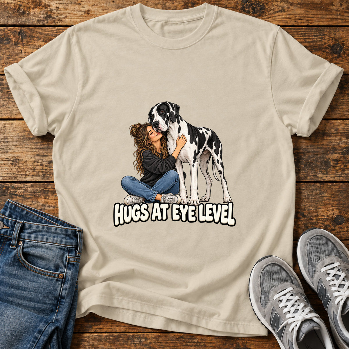 Hugs At Eye Great Dane graphic T-shirt in Sand, shown on a flat-lay shirt mockup