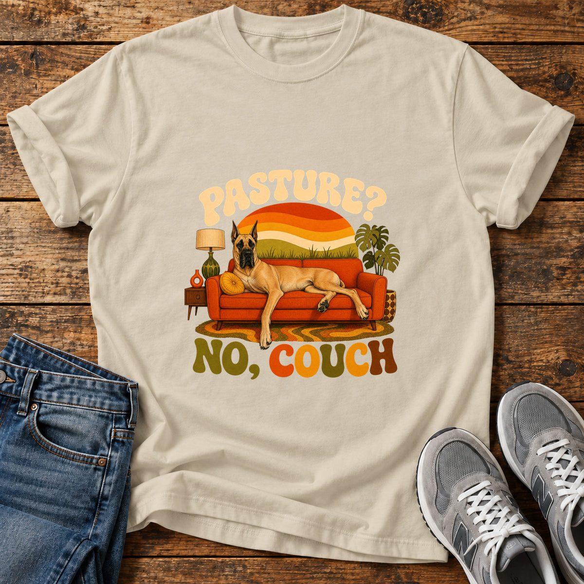Pasture No Couch Great Dane graphic T-shirt in Sand, shown on a flat-lay shirt mockup