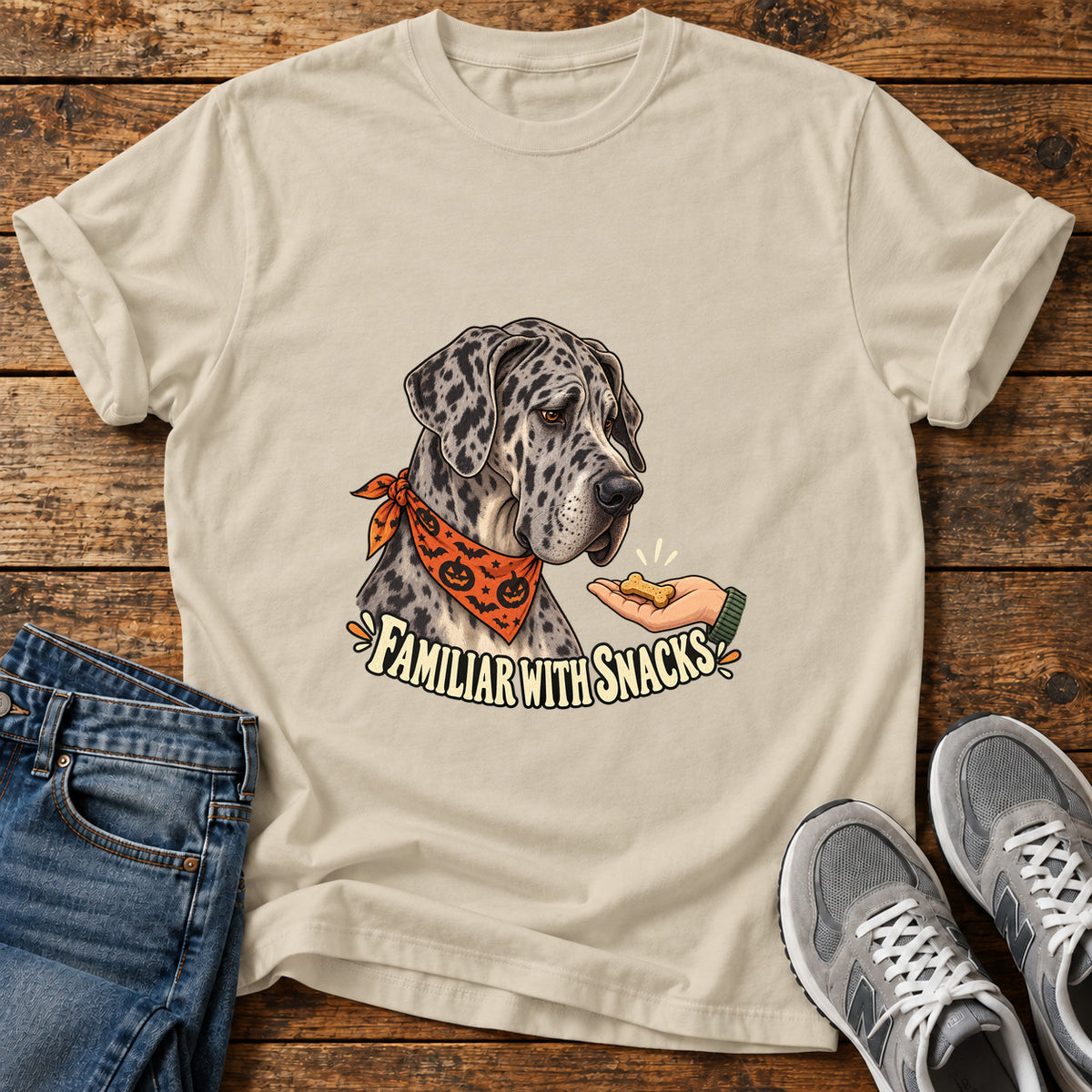 Familiar Snacks Great Dane graphic T-shirt in Sand, shown on a flat-lay shirt mockup