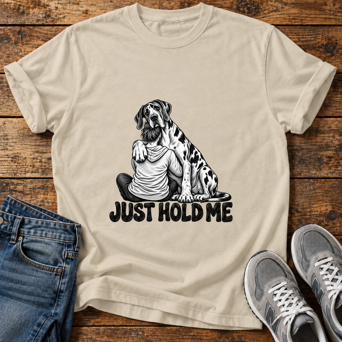 Just Hold Me Great Dane graphic T-shirt in Sand, shown on a flat-lay shirt mockup