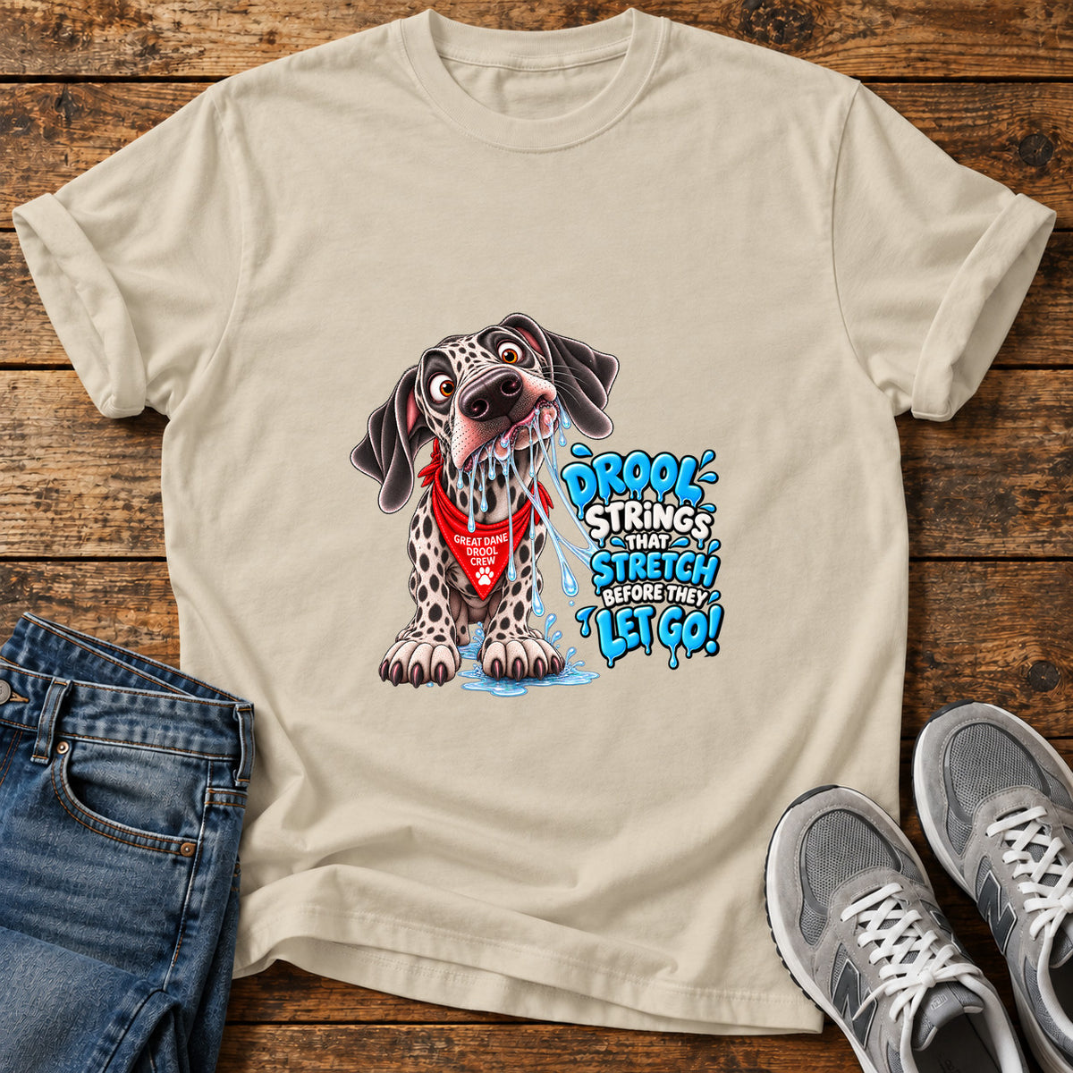 Drool Strings Great Dane graphic T-shirt in Sand, shown on a flat-lay shirt mockup
