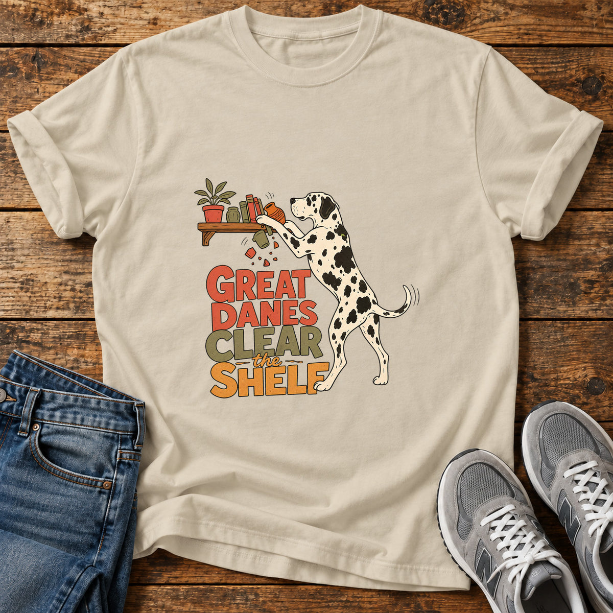 Great Danes Shelf graphic T-shirt in Sand, shown on a flat-lay shirt mockup