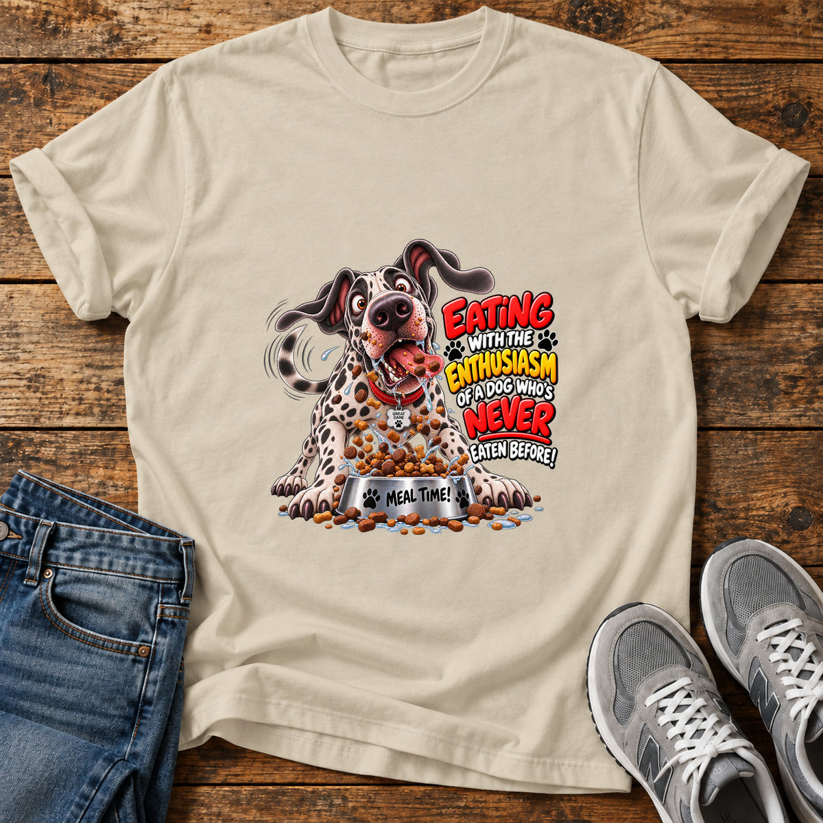 Eating Enthusiasm Great Dane graphic T-shirt in Sand, shown on a flat-lay shirt mockup