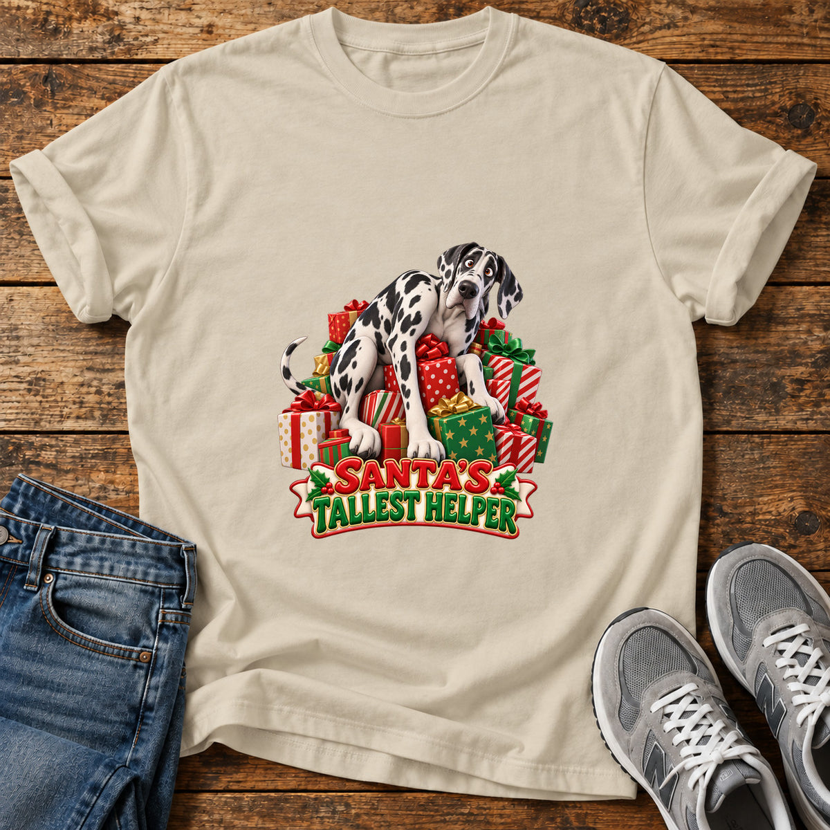 Santa's Tallest Helper Great Dane graphic T-shirt in Sand, shown on a flat-lay shirt mockup