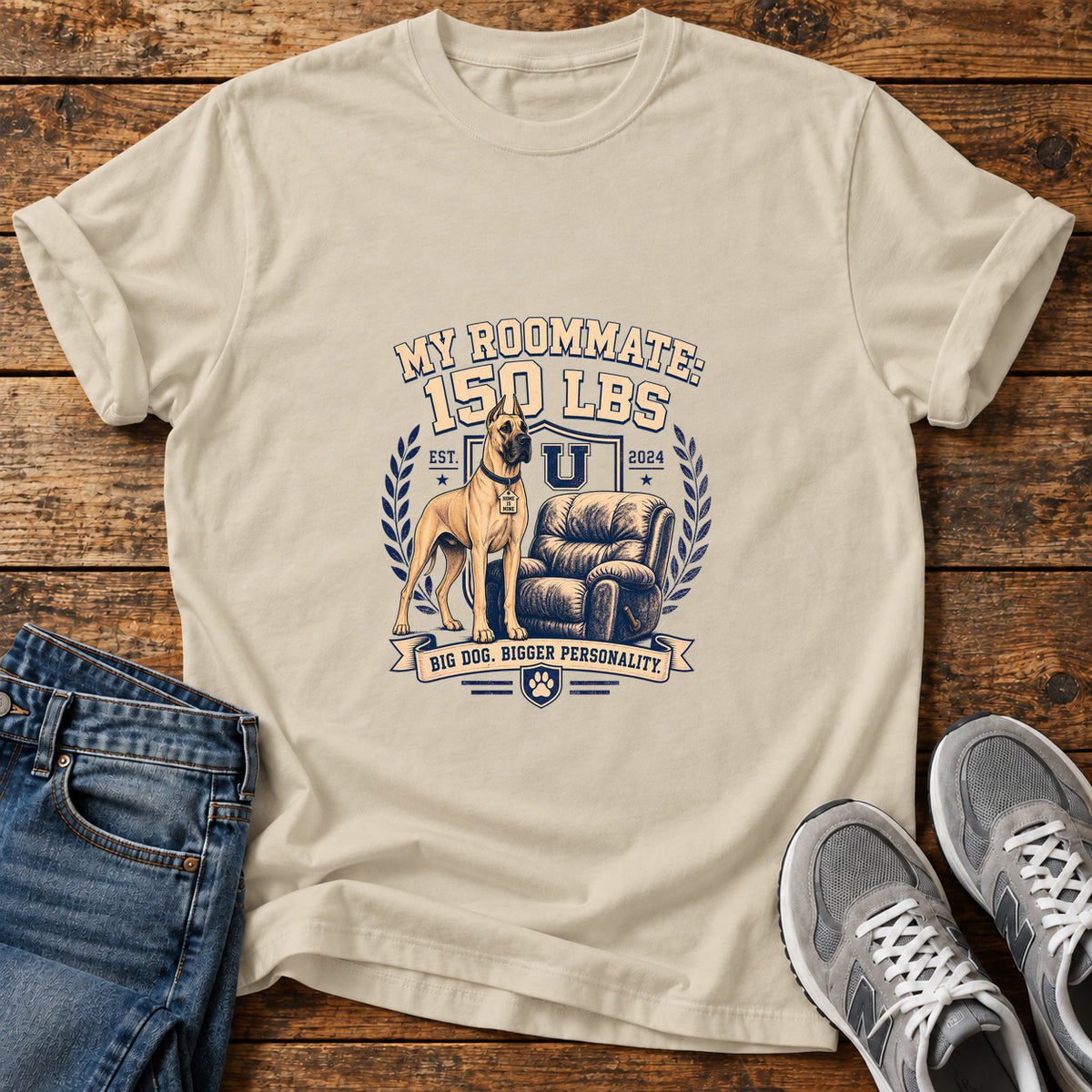 Roommate Pup Great Dane graphic T-shirt in Sand, shown on a flat-lay shirt mockup