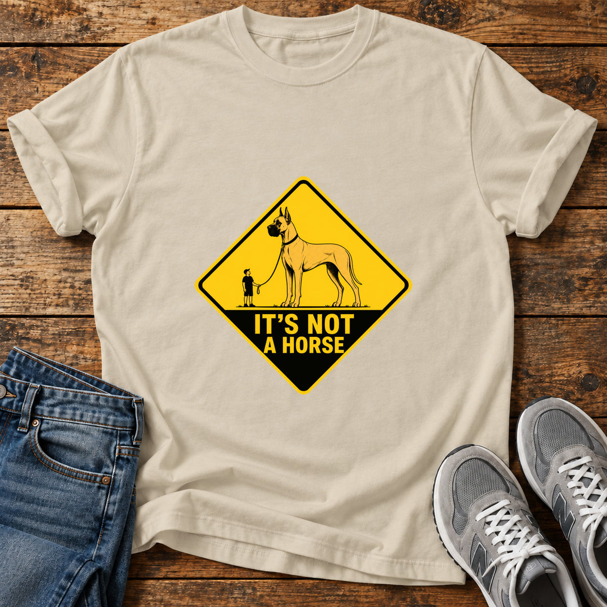 It's Not Horse Great Dane graphic T-shirt in Sand, shown on a flat-lay shirt mockup