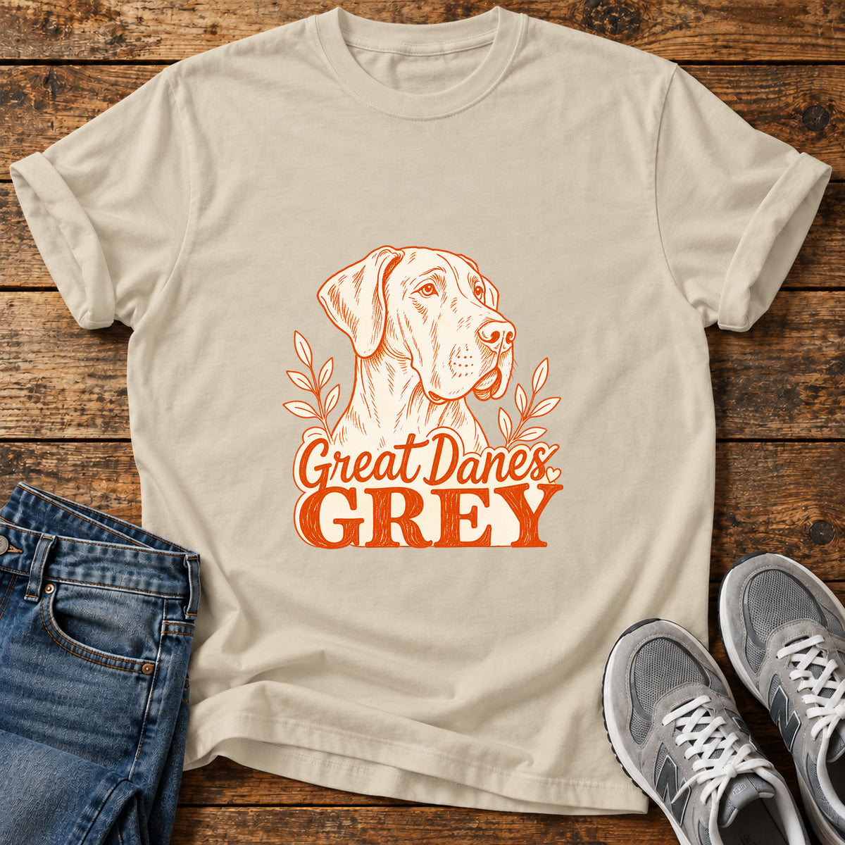 Great Danes Grey graphic T-shirt in Sand, shown on a flat-lay shirt mockup