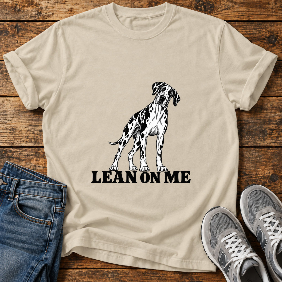 Lean On Me Great Dane graphic T-shirt in Sand, shown on a flat-lay shirt mockup