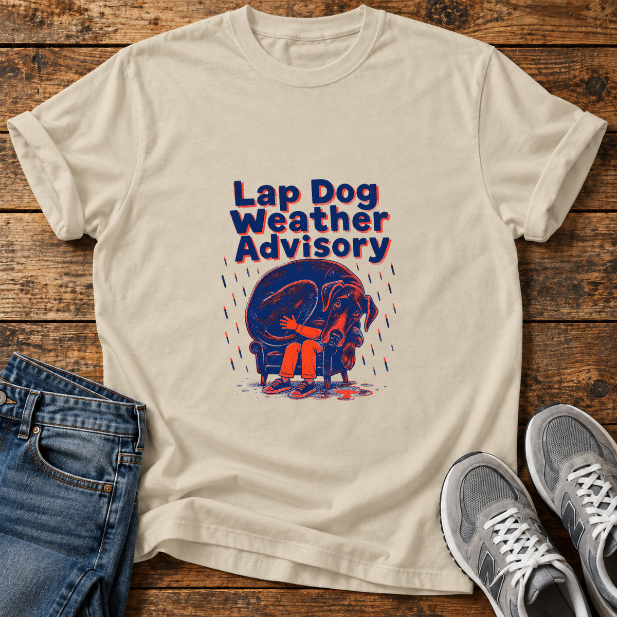 Lap Dog Weather Great Dane graphic T-shirt in Sand, shown on a flat-lay shirt mockup