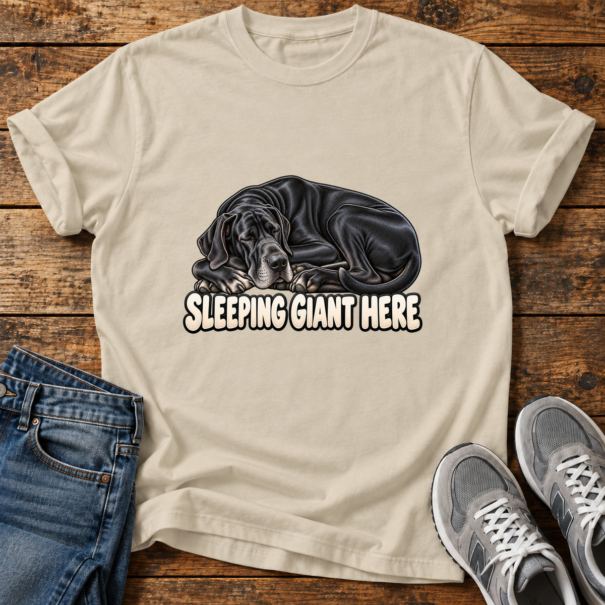 Sleeping Giant Great Dane graphic T-shirt in Sand, shown on a flat-lay shirt mockup