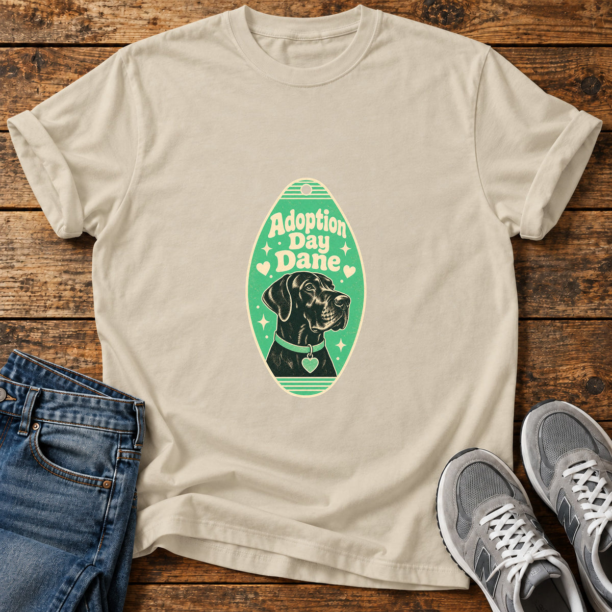 Adoption Day Dane Great Dane graphic T-shirt in Sand, shown on a flat-lay shirt mockup