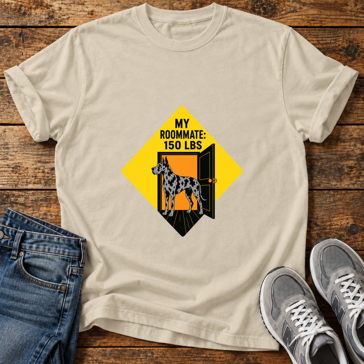 Roommate Dog Great Dane graphic T-shirt in Sand, shown on a flat-lay shirt mockup