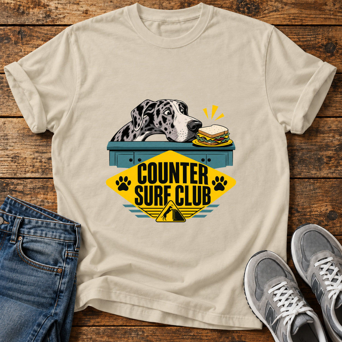 Counter Surf Club Great Dane graphic T-shirt in Sand, shown on a flat-lay shirt mockup