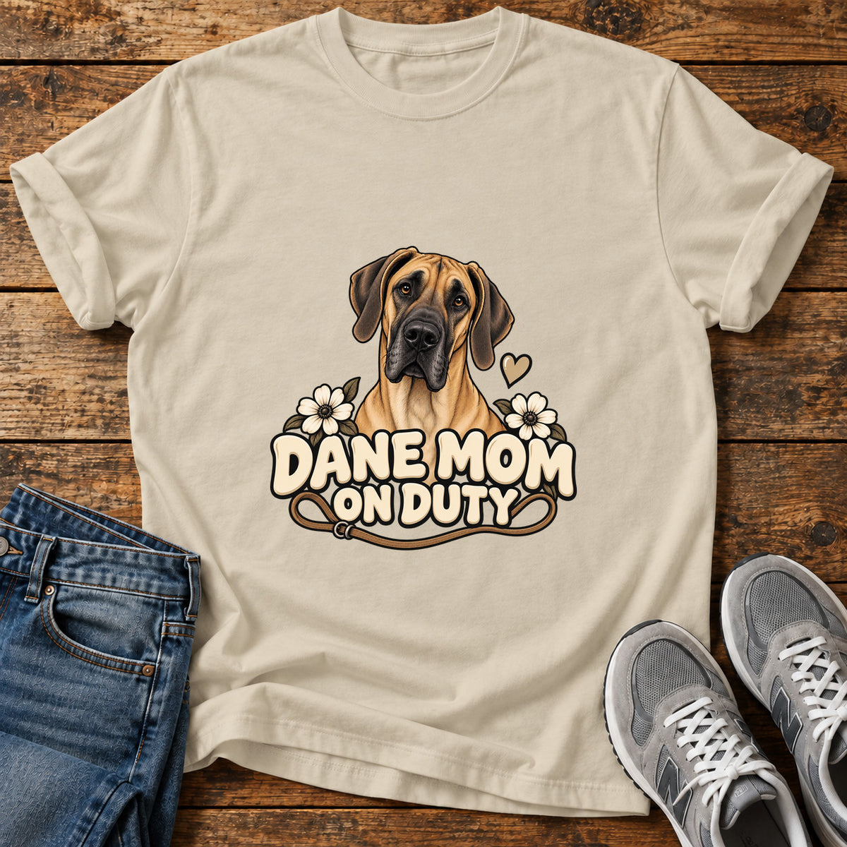 Dane Mom Duty Great Dane graphic T-shirt in Sand, shown on a flat-lay shirt mockup