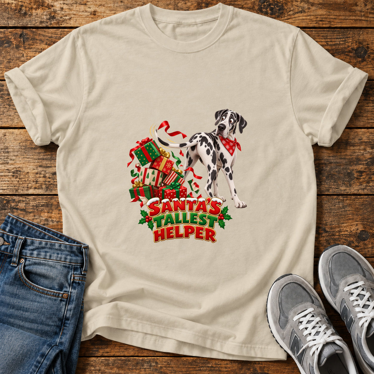 Santa's Tallest Helper Great Dane graphic T-shirt in Sand, shown on a flat-lay shirt mockup