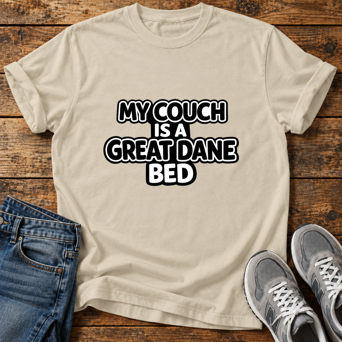 Great Dane Bed graphic T-shirt in Sand, shown on a flat-lay shirt mockup
