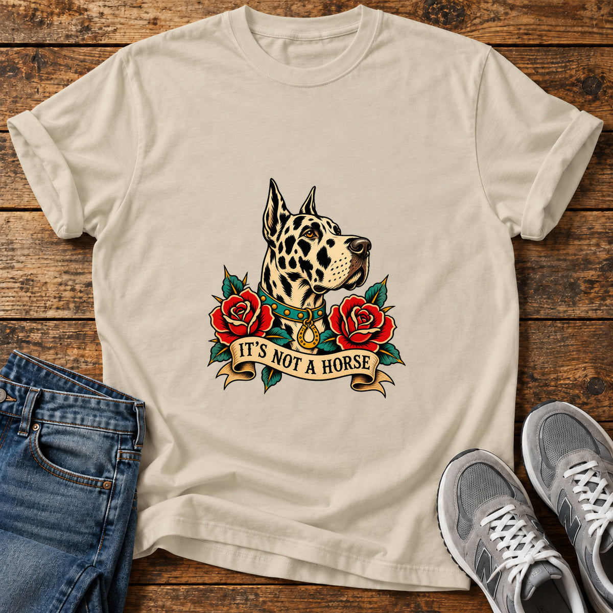 It's Not A Great Dane graphic T-shirt in Sand, shown on a flat-lay shirt mockup