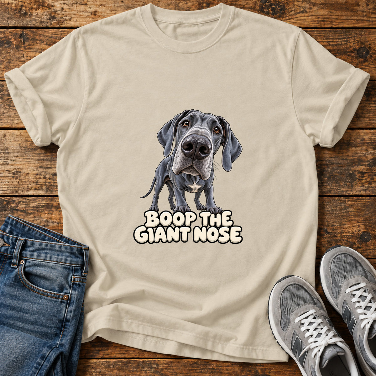 Boop Giant Nose Great Dane graphic T-shirt in Sand, shown on a flat-lay shirt mockup