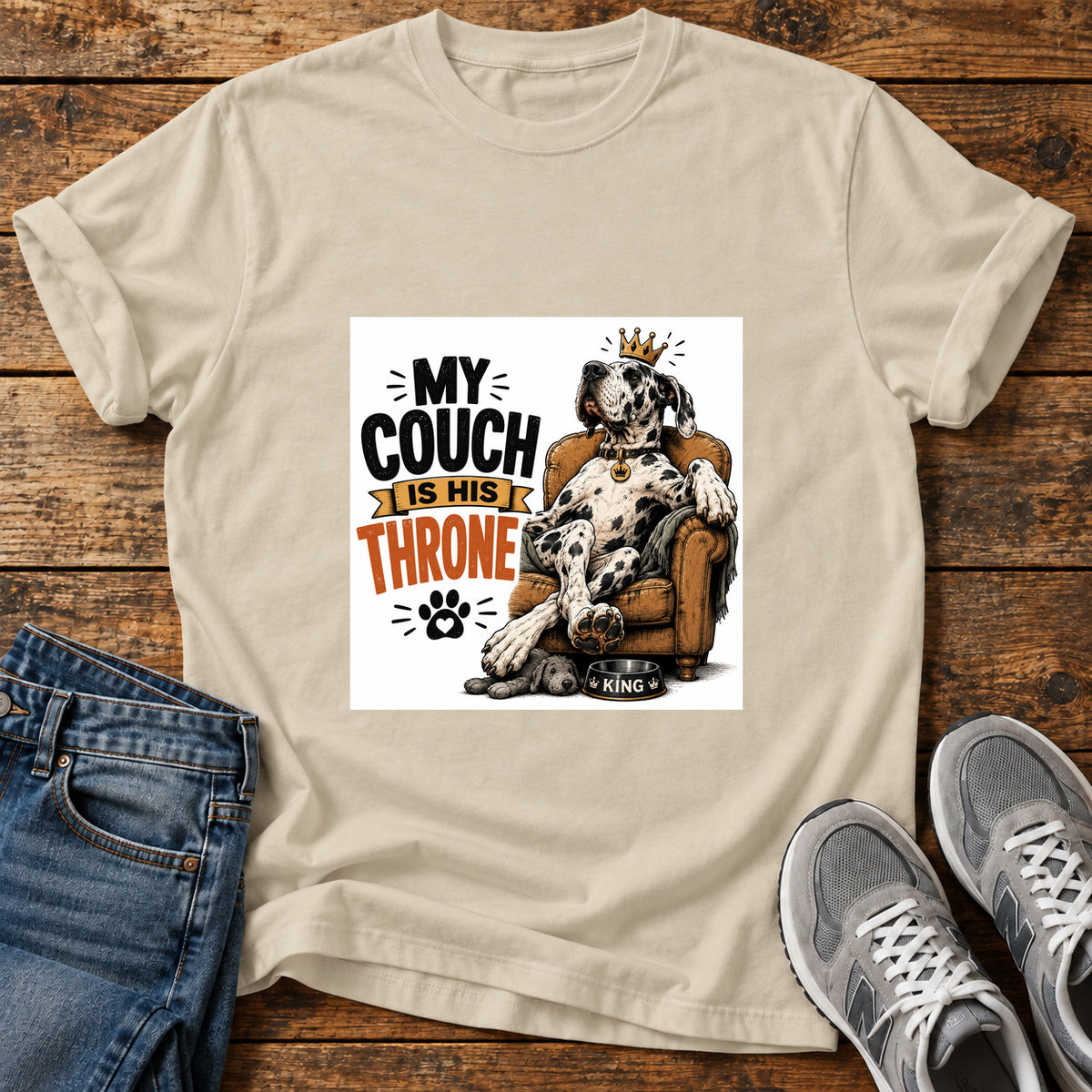 Couch Throne Great Dane graphic T-shirt in Sand, shown on a flat-lay shirt mockup