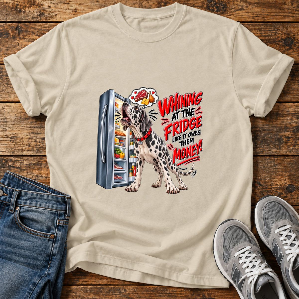 Whining Fridge Dog Great Dane graphic T-shirt in Sand, shown on a flat-lay shirt mockup