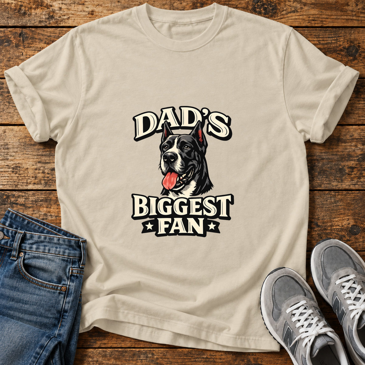 Dad's Biggest Fan Great Dane graphic T-shirt in Sand, shown on a flat-lay shirt mockup