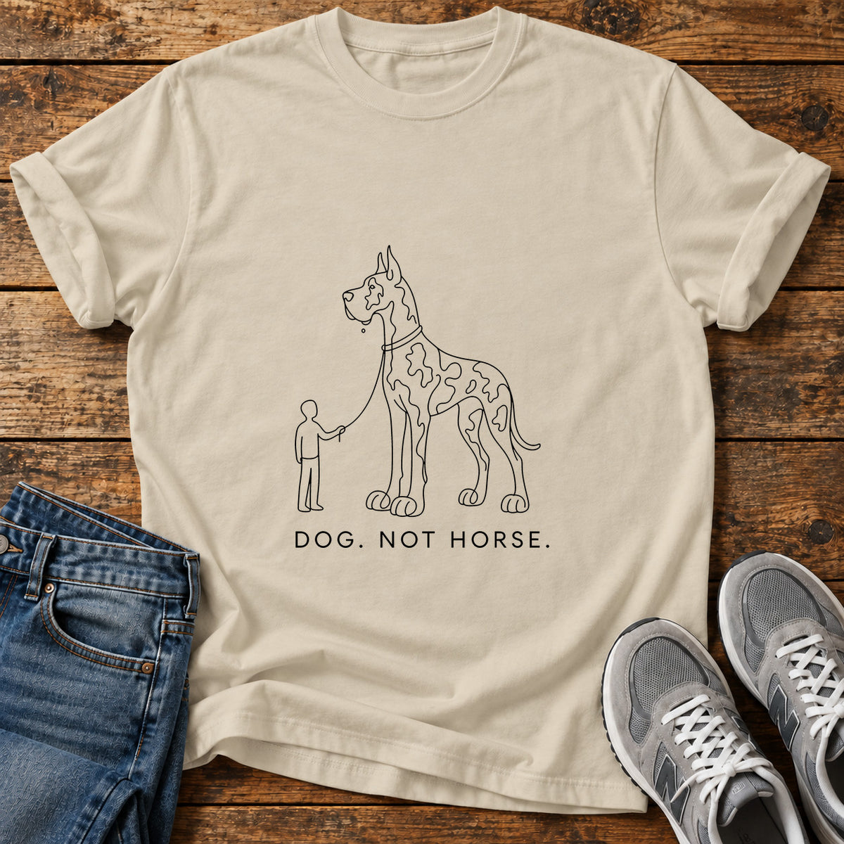 Dog Not Horse Great Dane graphic T-shirt in Sand, shown on a flat-lay shirt mockup