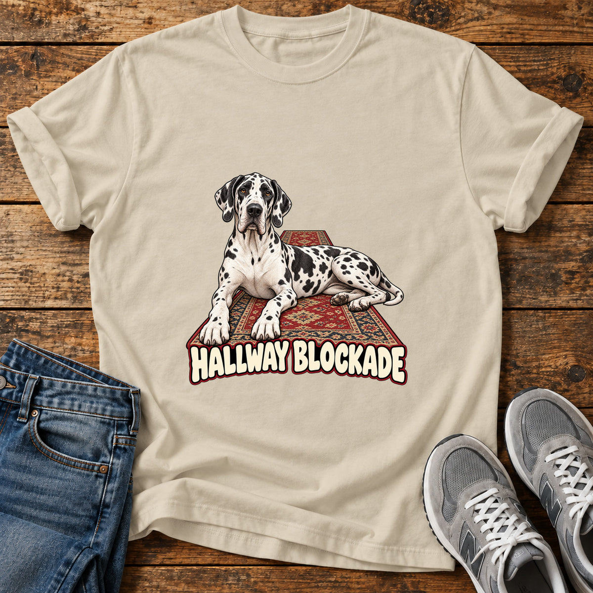 Hallway Blockade Great Dane graphic T-shirt in Sand, shown on a flat-lay shirt mockup