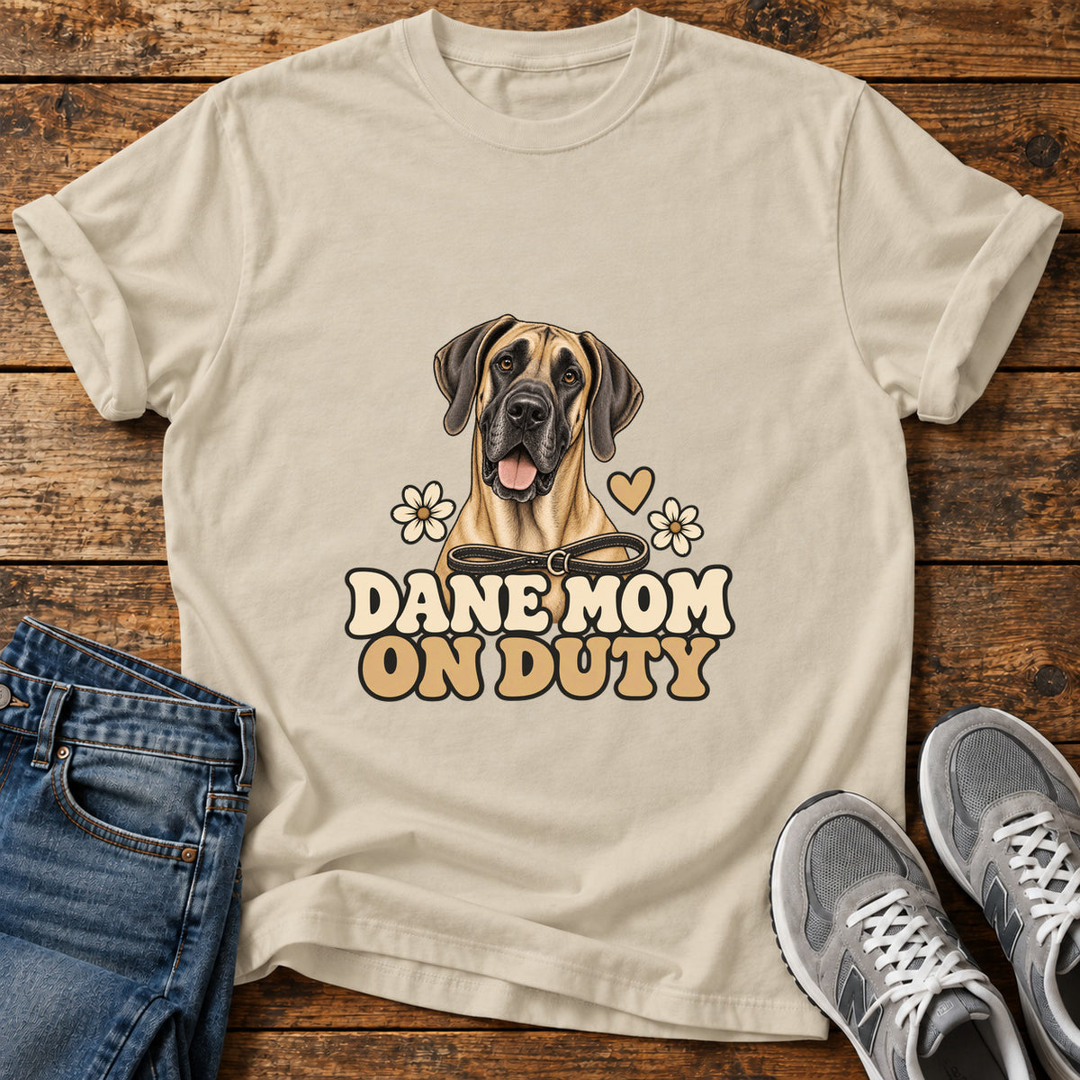 Dane Mom Duty Great Dane graphic T-shirt in Sand, shown on a flat-lay shirt mockup