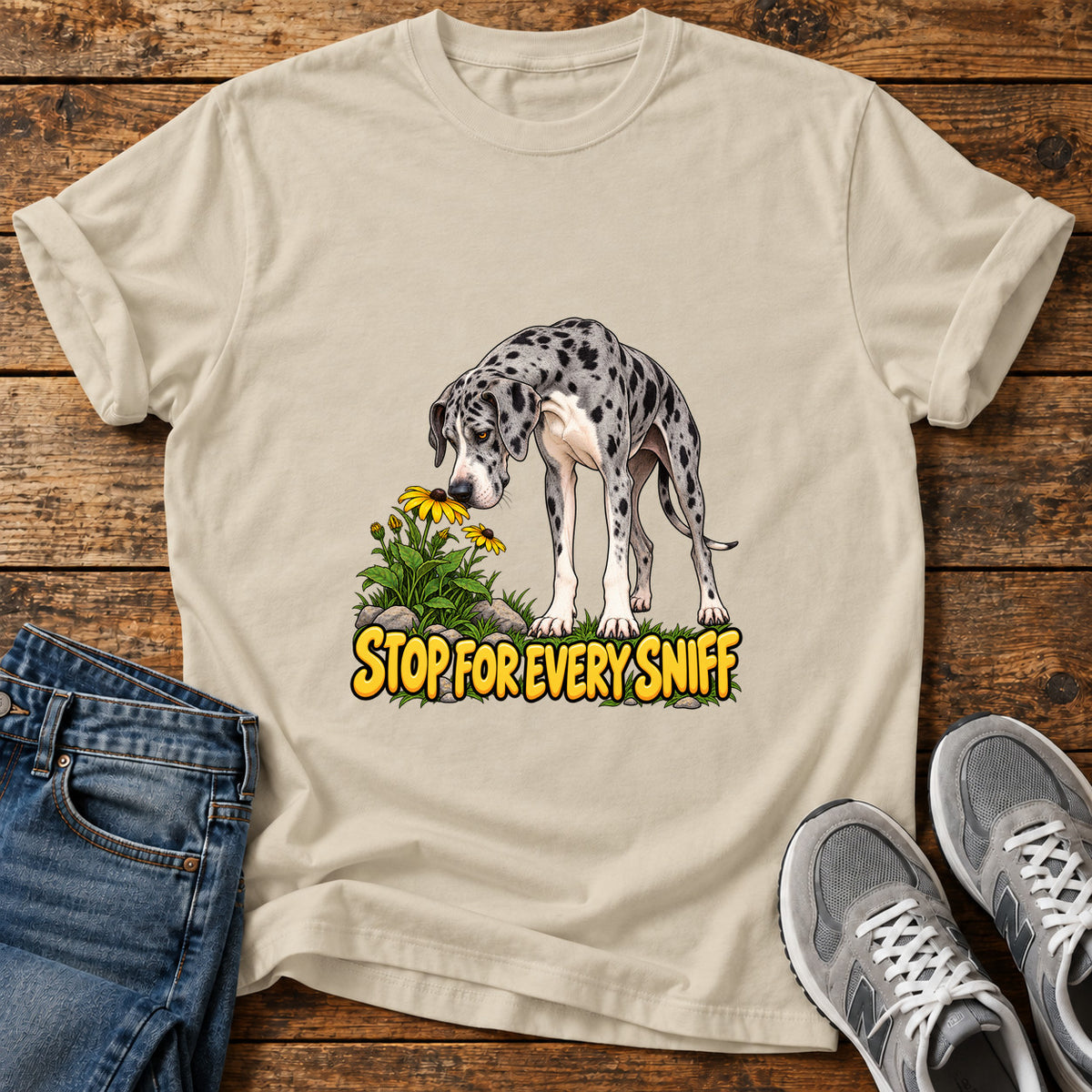 Stop Sniffing Time Great Dane graphic T-shirt in Sand, shown on a flat-lay shirt mockup