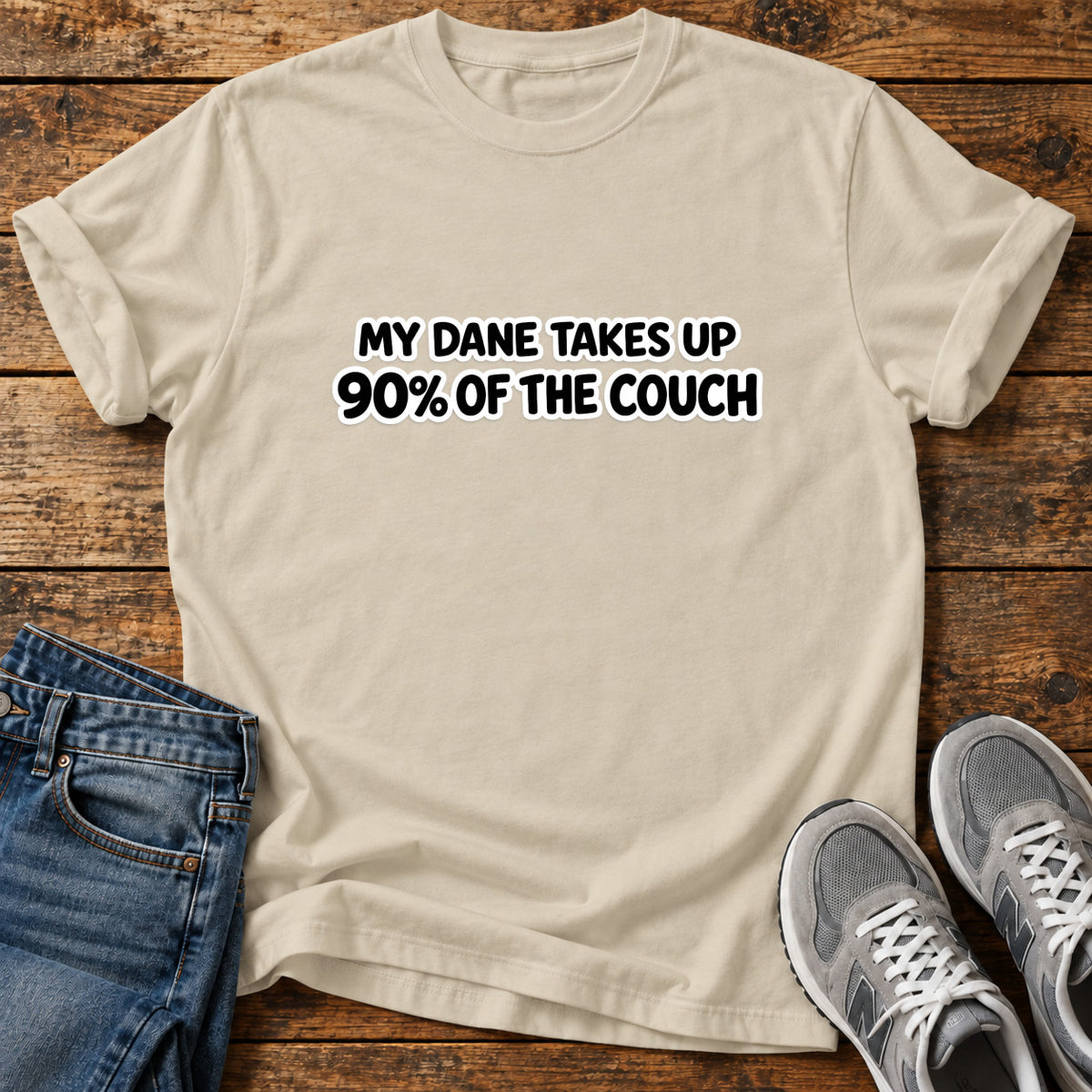 Dane Couch Hog Great Dane graphic T-shirt in Sand, shown on a flat-lay shirt mockup