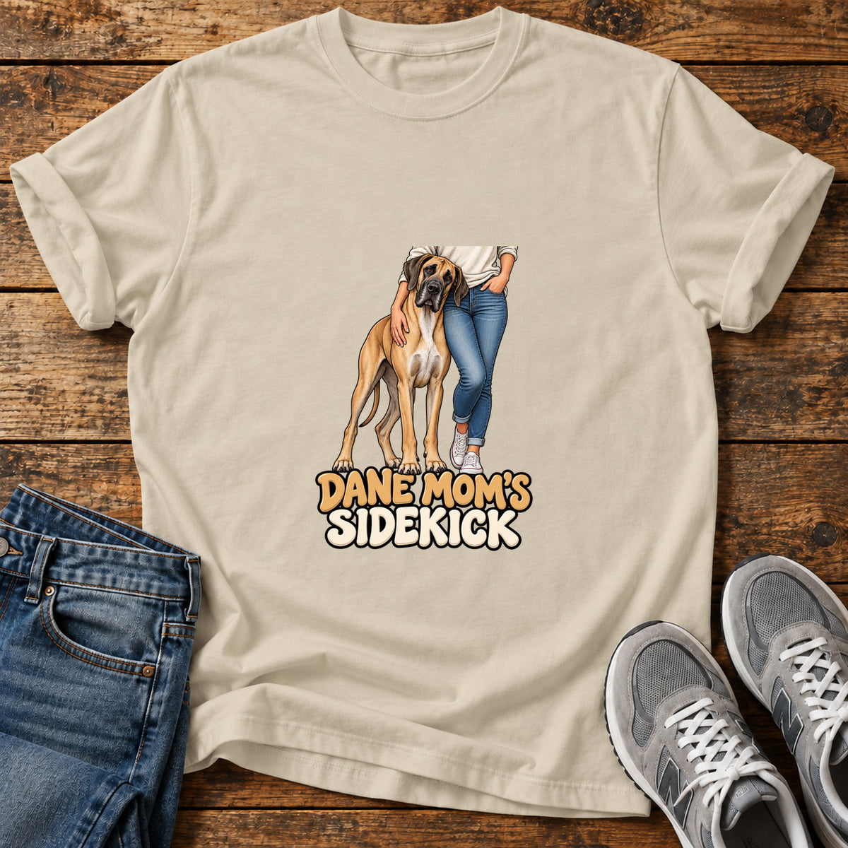 Dane Mom's Sidekick Great Dane graphic T-shirt in Sand, shown on a flat-lay shirt mockup