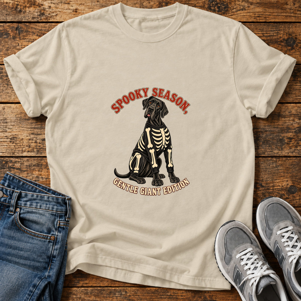 Spooky Gentle Giant Great Dane graphic T-shirt in Sand, shown on a flat-lay shirt mockup