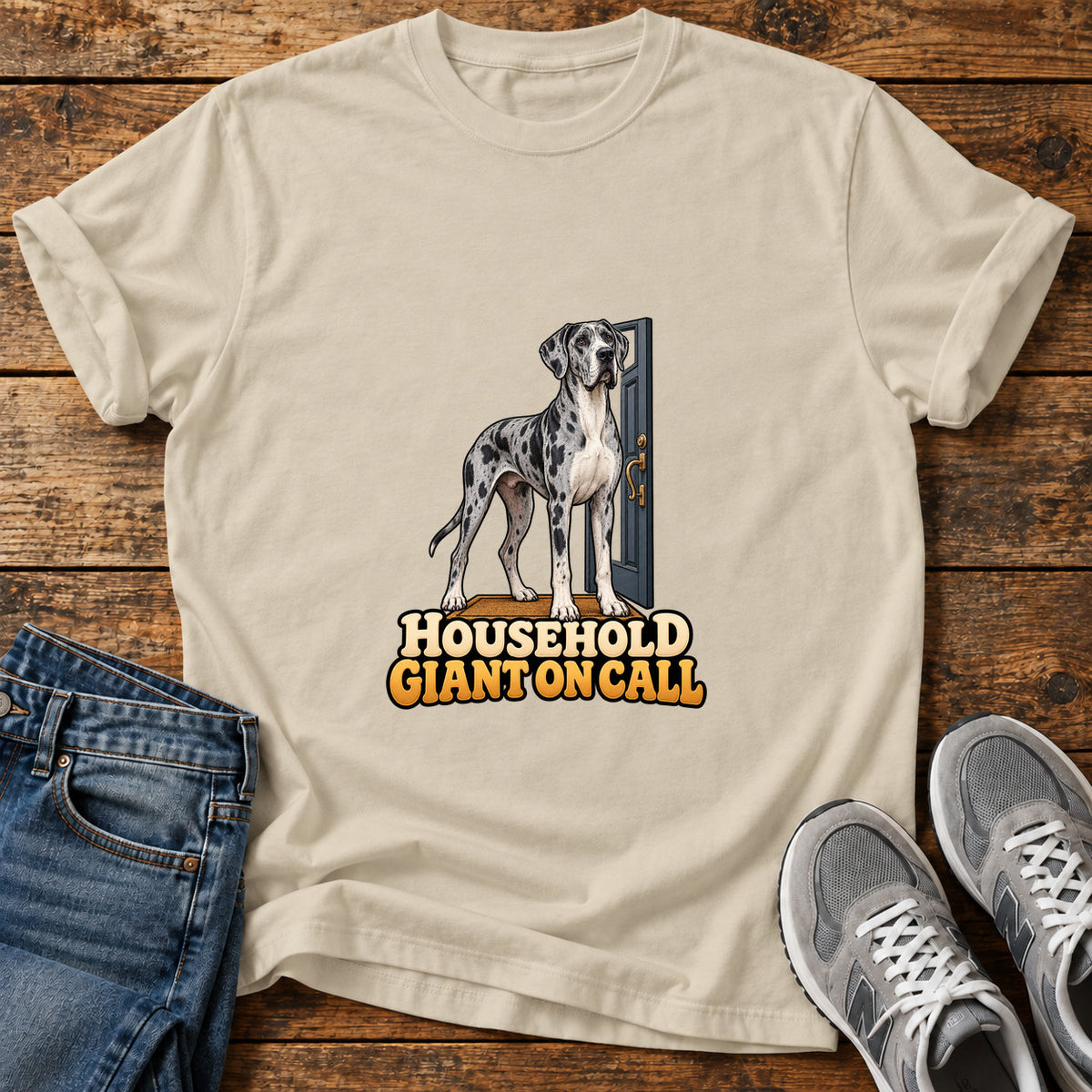 Household Giant Great Dane graphic T-shirt in Sand, shown on a flat-lay shirt mockup