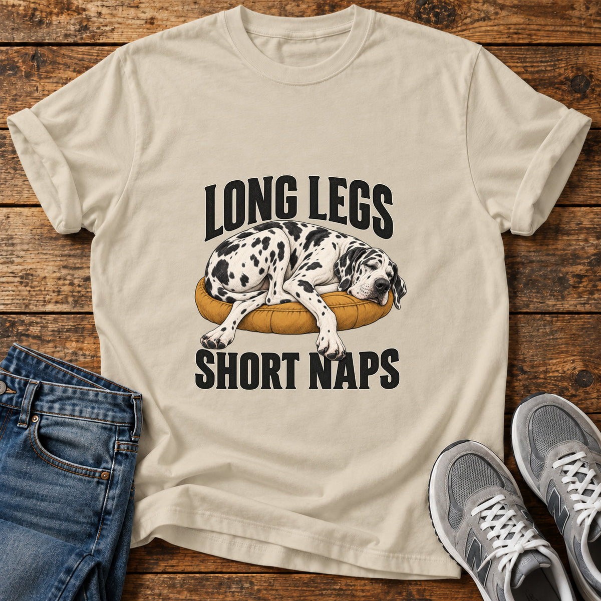 Long Legs Naps Great Dane graphic T-shirt in Sand, shown on a flat-lay shirt mockup