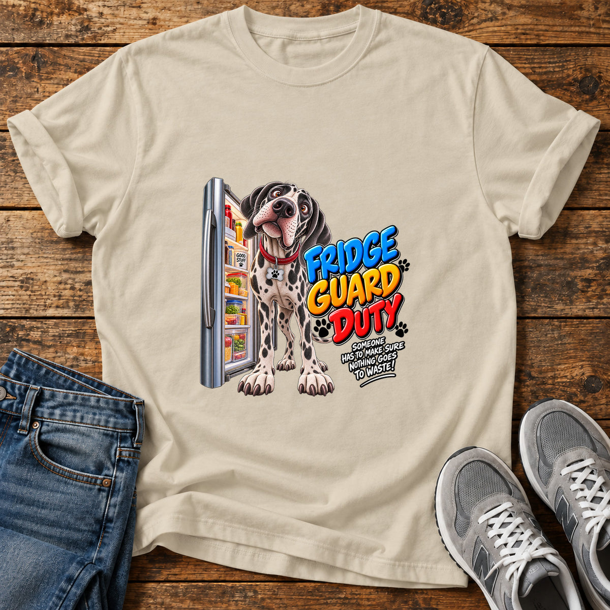 Fridge Guard Duty Great Dane graphic T-shirt in Sand, shown on a flat-lay shirt mockup