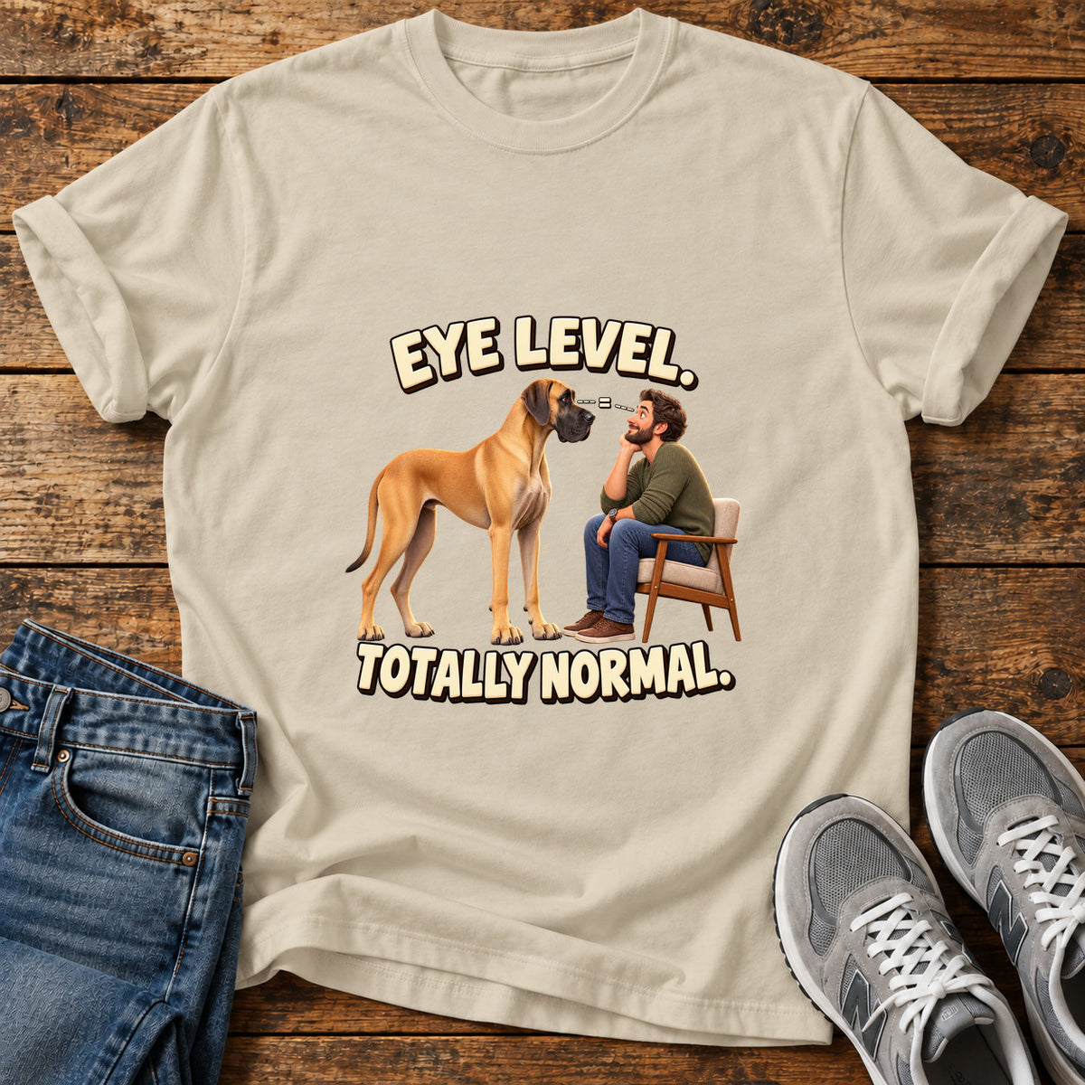 Eye Level Normal Great Dane graphic T-shirt in Sand, shown on a flat-lay shirt mockup