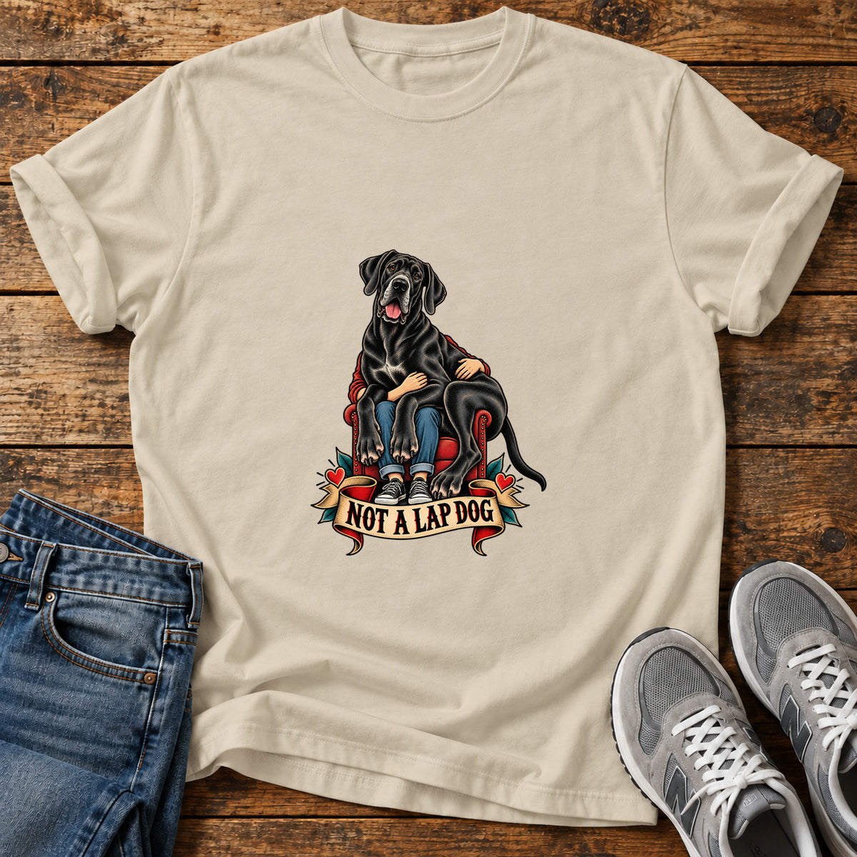 Not A Lapdog Great Dane graphic T-shirt in Sand, shown on a flat-lay shirt mockup