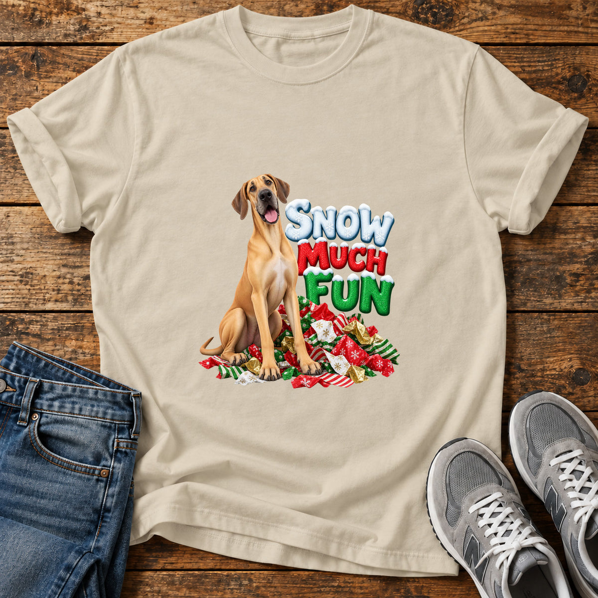 Snow Much Fun Great Dane graphic T-shirt in Sand, shown on a flat-lay shirt mockup