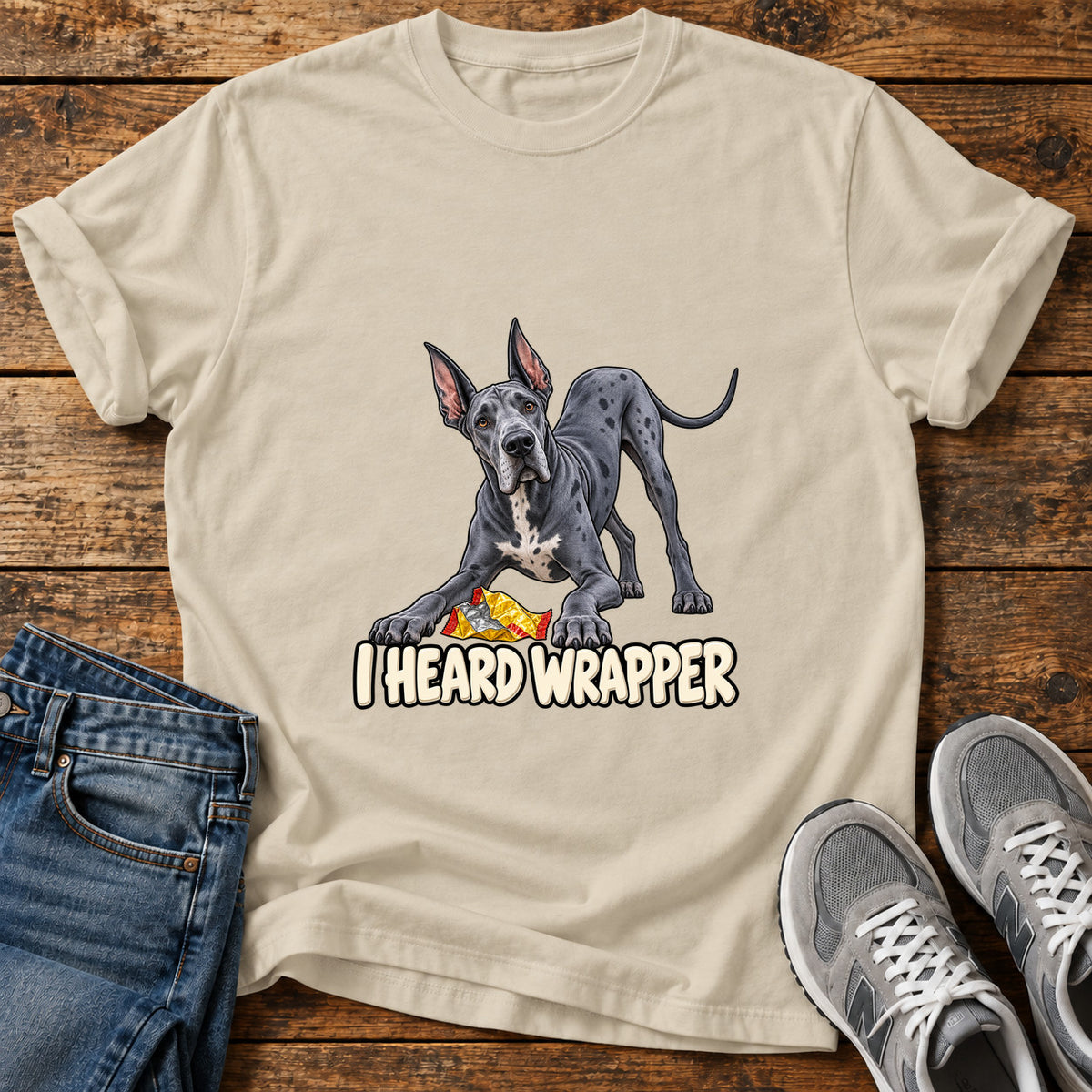 I Heard Wrapper Great Dane graphic T-shirt in Sand, shown on a flat-lay shirt mockup