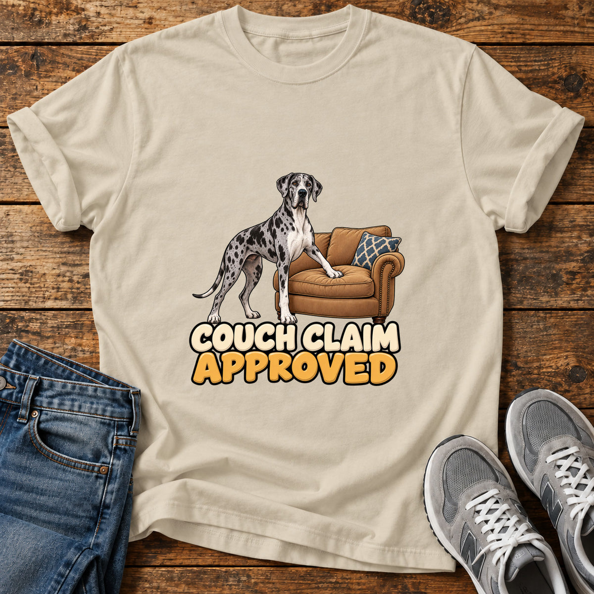 Couch Claim Approved Great Dane graphic T-shirt in Sand, shown on a flat-lay shirt mockup