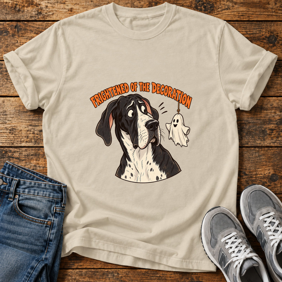 Frightened Decoration Great Dane graphic T-shirt in Sand, shown on a flat-lay shirt mockup