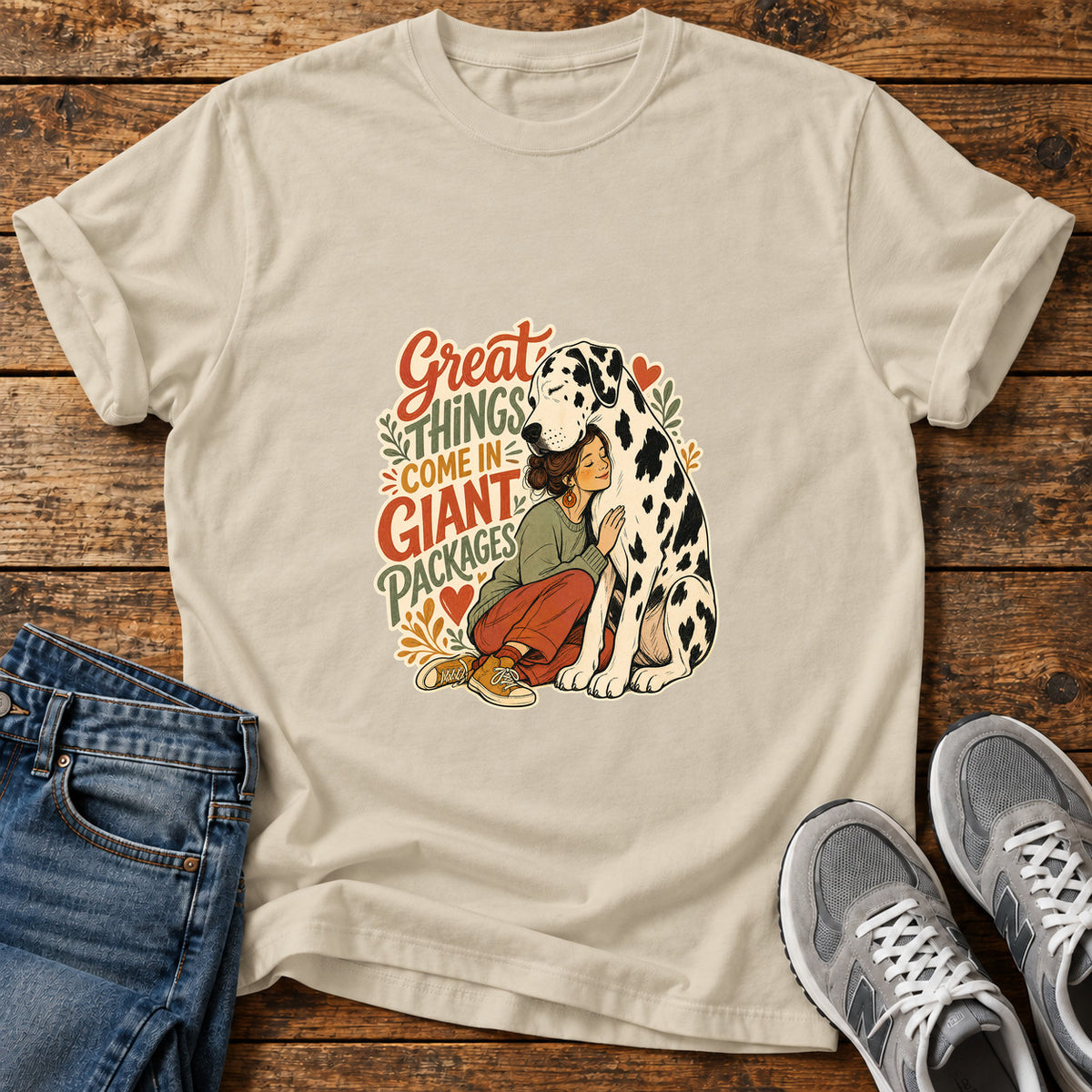 Giant Packages Great Dane graphic T-shirt in Sand, shown on a flat-lay shirt mockup