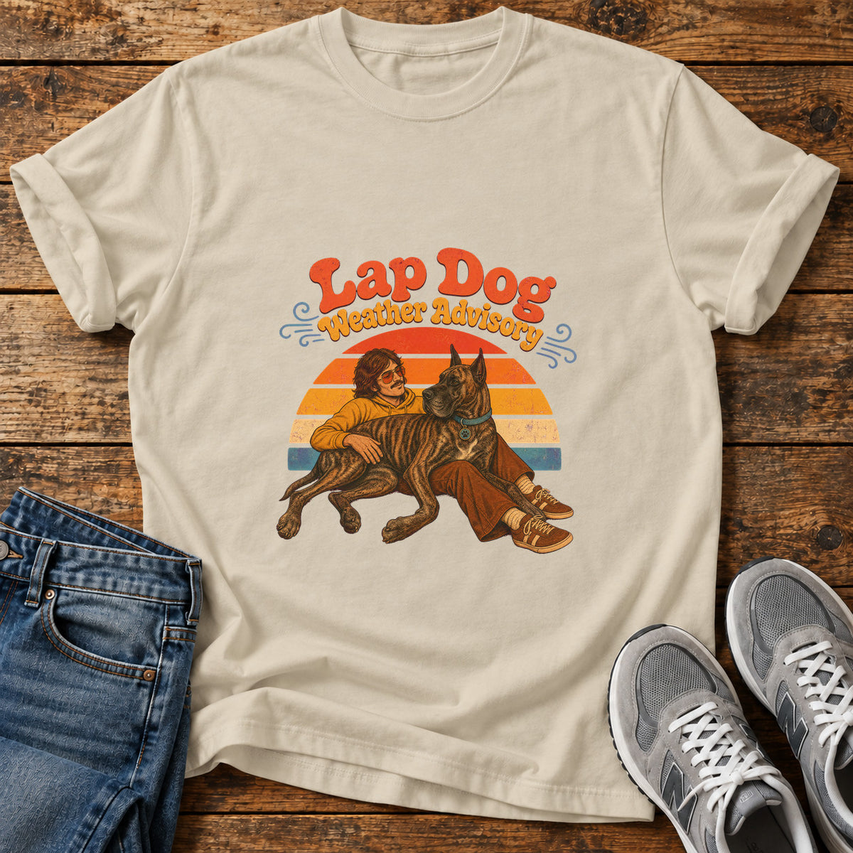 Lap Dog Advisory Great Dane graphic T-shirt in Sand, shown on a flat-lay shirt mockup