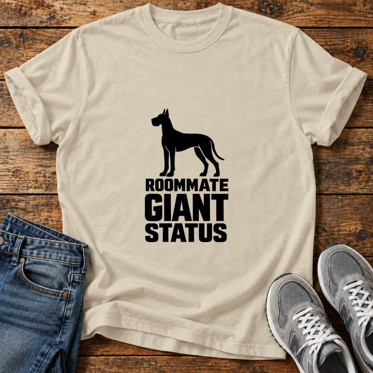 Roommate Giant Status Great Dane graphic T-shirt in Sand, shown on a flat-lay shirt mockup